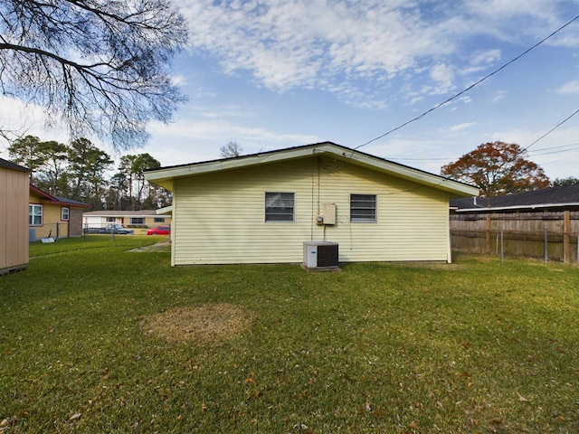 rear view of property with a lawn