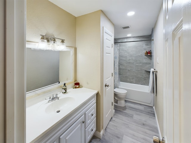 full bathroom featuring hardwood / wood-style flooring, vanity, toilet, and shower / bath combo