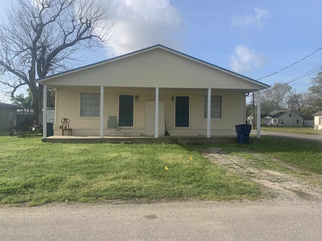 bungalow-style home featuring a front yard and covered porch