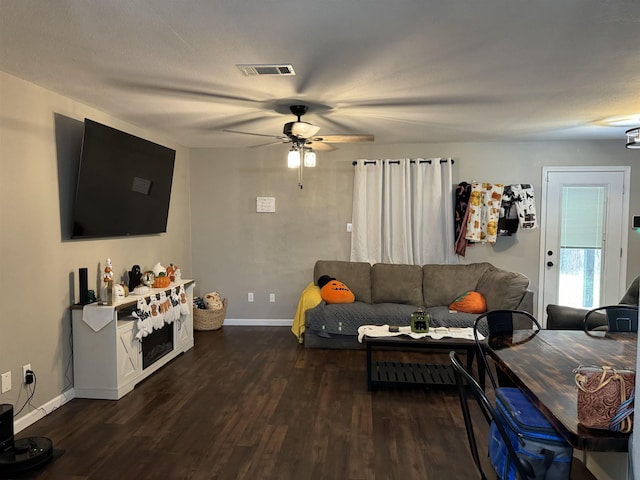 living room with dark hardwood / wood-style floors and ceiling fan