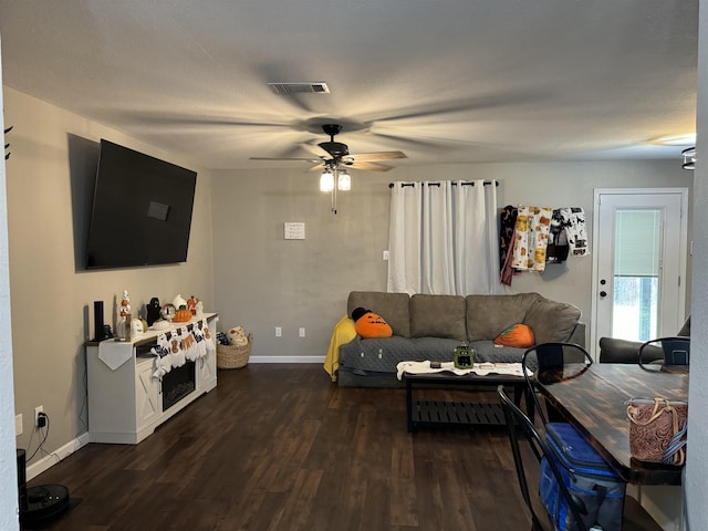 living room with dark hardwood / wood-style floors and ceiling fan