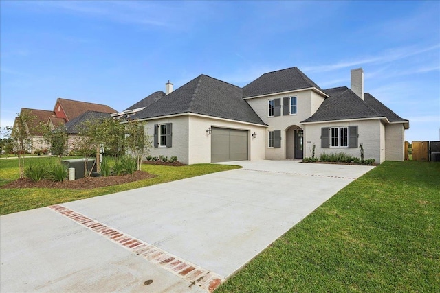 6588 Pointe Park, Beaumont, TX 77706 - traditional-style home featuring a chimney, concrete driveway, a front lawn, and a garage