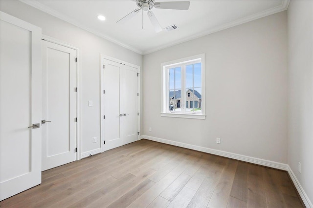 6588 Pointe Park, Beaumont, TX 77706 - unfurnished bedroom featuring ornamental molding, wood finished floors, baseboards, two closets, and recessed lighting