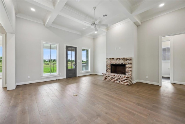 6588 Pointe Park, Beaumont, TX 77706 - unfurnished living room featuring coffered ceiling, beamed ceiling, ceiling fan, a brick fireplace, and dark wood-style flooring
