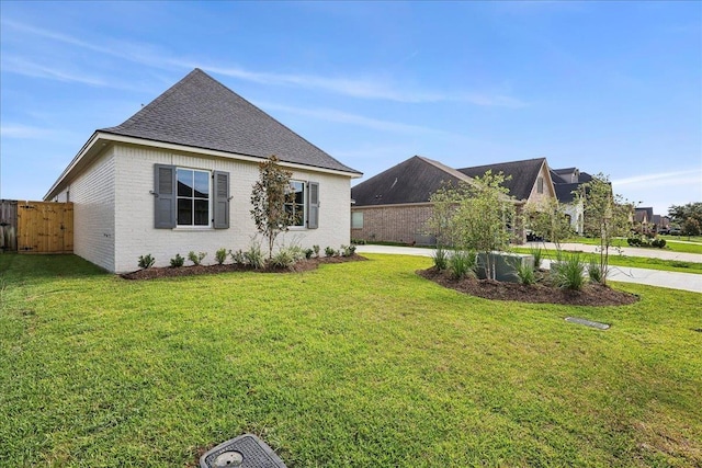 6588 Pointe Park, Beaumont, TX 77706 - view of property exterior featuring a shingled roof and brick siding