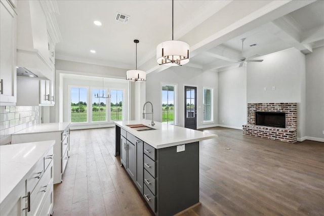 6588 Pointe Park, Beaumont, TX 77706 - kitchen with a sink, gray cabinetry, a chandelier, light countertops, and white cabinetry