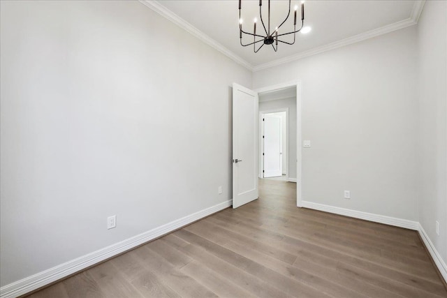 6588 Pointe Park, Beaumont, TX 77706 - unfurnished room with a chandelier, crown molding, wood finished floors, and baseboards