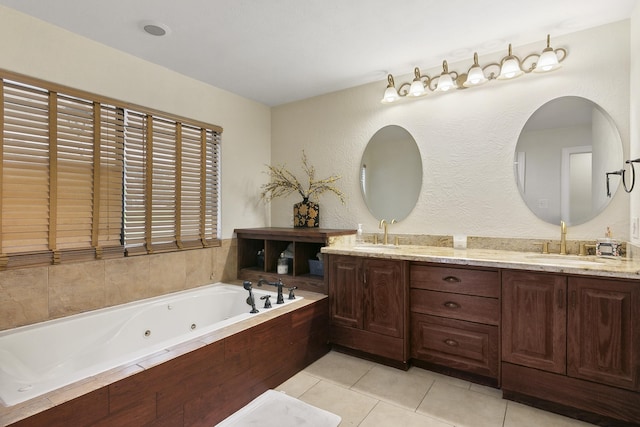 bathroom with tile patterned flooring, a bath, and vanity