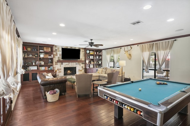 rec room featuring ceiling fan, dark hardwood / wood-style flooring, built in features, billiards, and a fireplace