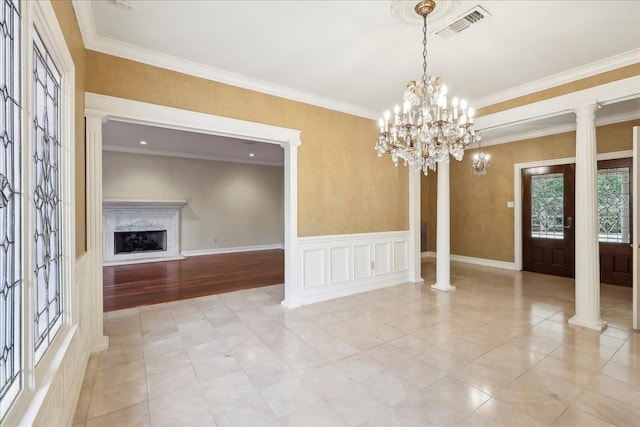 interior space with a fireplace, decorative columns, visible vents, and a healthy amount of sunlight