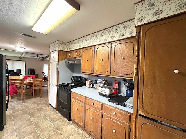 155 Hunters Ct, Lumberton, TX 77657 - kitchen featuring black appliances, under cabinet range hood, brown cabinetry, light countertops, and light tile patterned floors