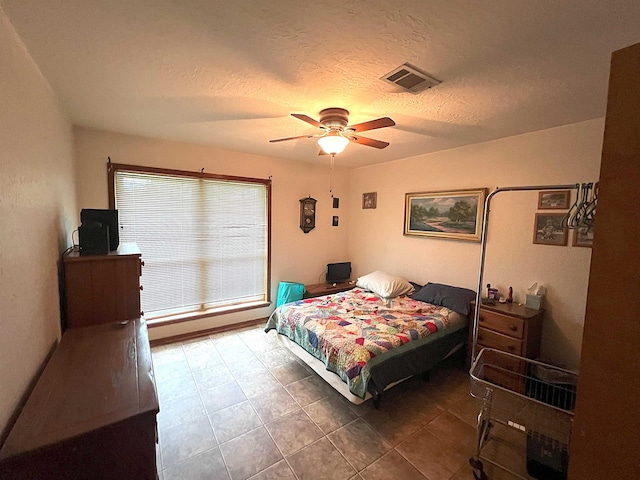 155 Hunters Ct, Lumberton, TX 77657 - tiled bedroom featuring a textured ceiling and a ceiling fan