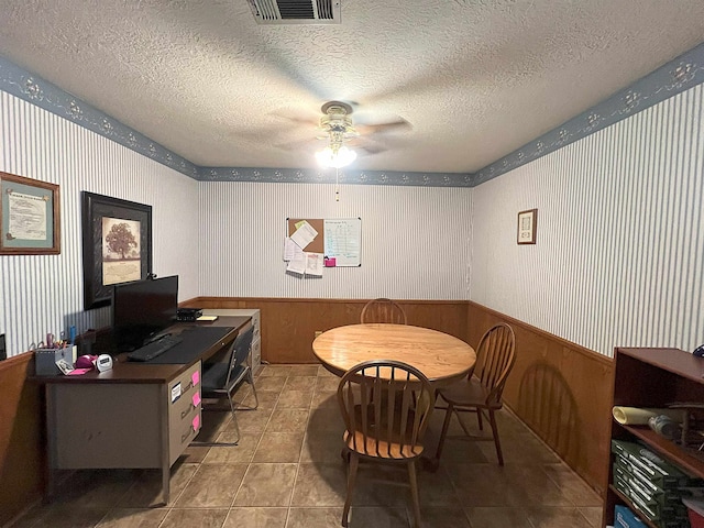 155 Hunters Ct, Lumberton, TX 77657 - tiled office space featuring a ceiling fan, wallpapered walls, a wainscoted wall, and a textured ceiling