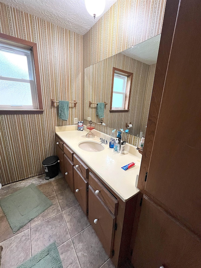 155 Hunters Ct, Lumberton, TX 77657 - bathroom featuring wallpapered walls, vanity, tile patterned flooring, a textured ceiling, and toilet