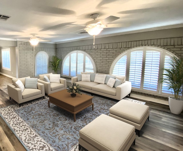 living area featuring visible vents, crown molding, wood finished floors, brick wall, and a ceiling fan