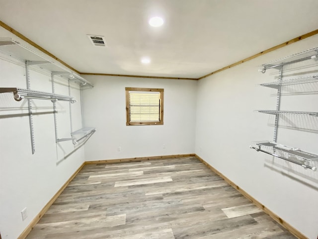 walk in closet featuring light wood-style flooring and visible vents