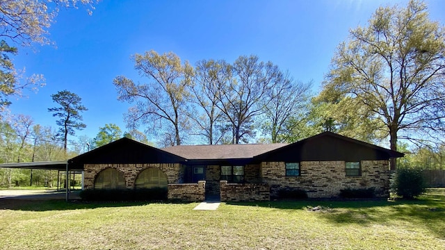 ranch-style home with brick siding, a carport, and a front lawn