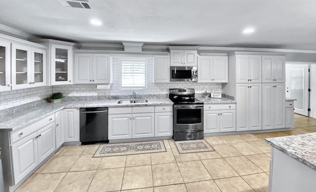 3900 Lakeview Cutoff, Vidor, TX 77662 - kitchen featuring appliances with stainless steel finishes, a sink, backsplash, crown molding, and white cabinets