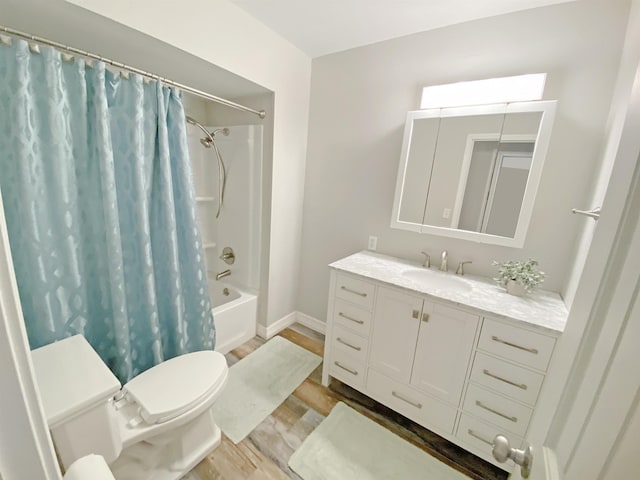 bathroom with vanity, toilet, shower / bathtub combination with curtain, baseboards, and wood finished floors