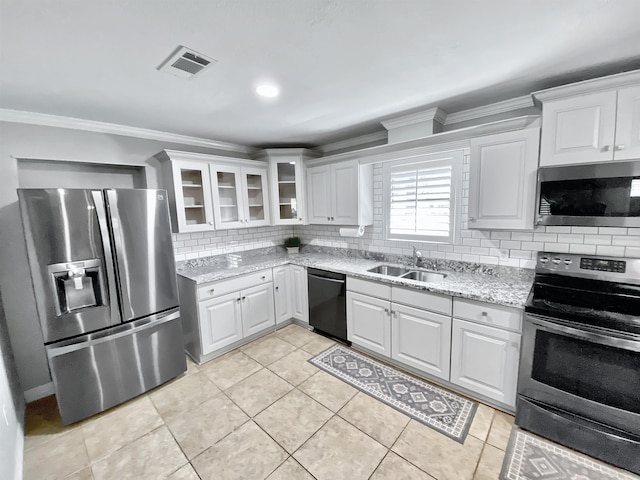 kitchen with decorative backsplash, visible vents, crown molding, a sink, and stainless steel appliances