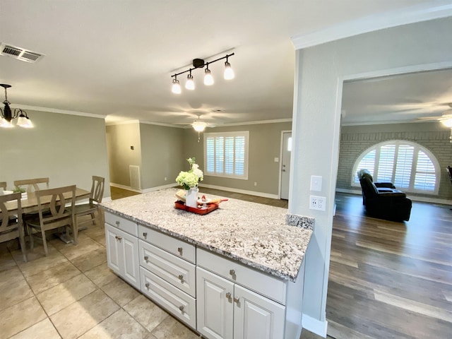 3900 Lakeview Cutoff, Vidor, TX 77662 - kitchen featuring a ceiling fan, crown molding, white cabinetry, a chandelier, and pendant lighting