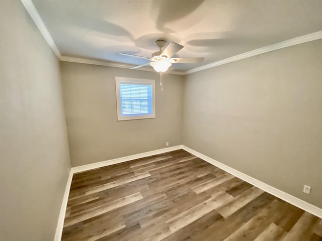 unfurnished room with crown molding, dark wood finished floors, ceiling fan, and baseboards