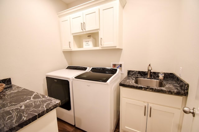 clothes washing area featuring cabinets, washing machine and dryer, and sink