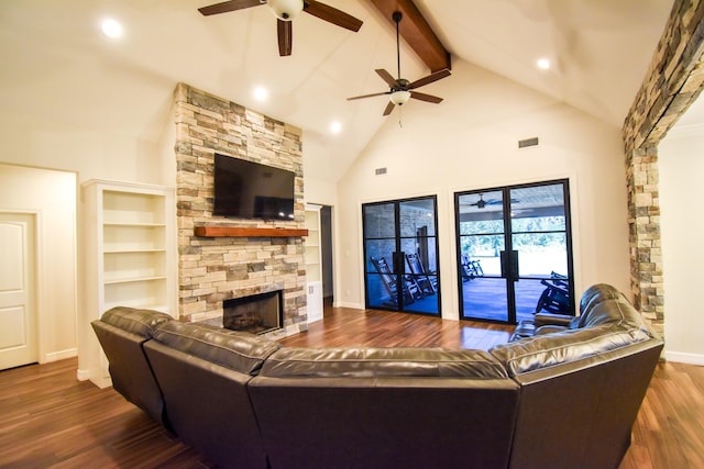 living room featuring beam ceiling, built in features, high vaulted ceiling, a fireplace, and hardwood / wood-style flooring