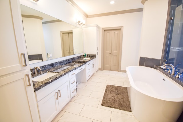 bathroom featuring vanity, a tub to relax in, tile patterned floors, and ornamental molding