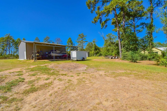 view of yard with an outbuilding and a carport