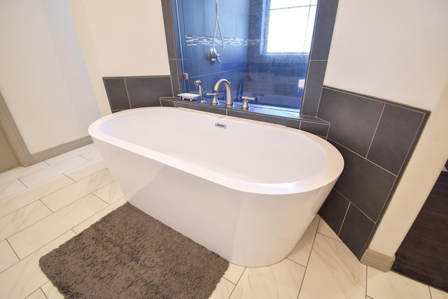 bathroom featuring a bathtub, tile walls, and tile patterned flooring