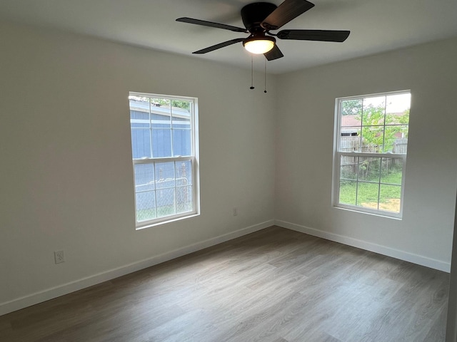 spare room with hardwood / wood-style flooring and ceiling fan