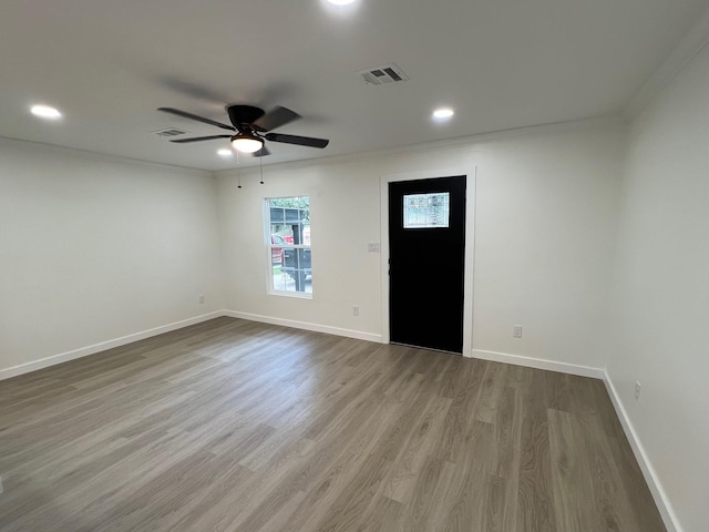 foyer featuring hardwood / wood-style flooring, ceiling fan, and crown molding