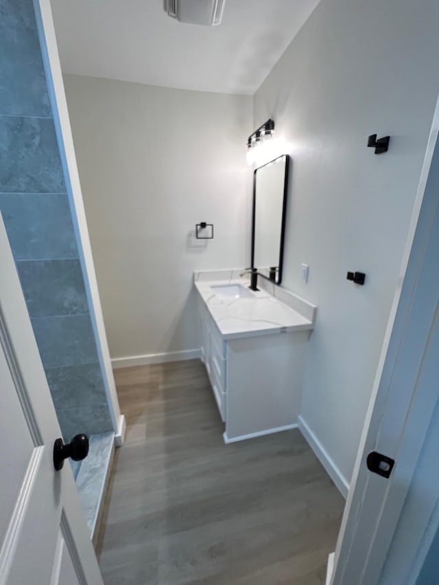 bathroom featuring hardwood / wood-style floors and vanity