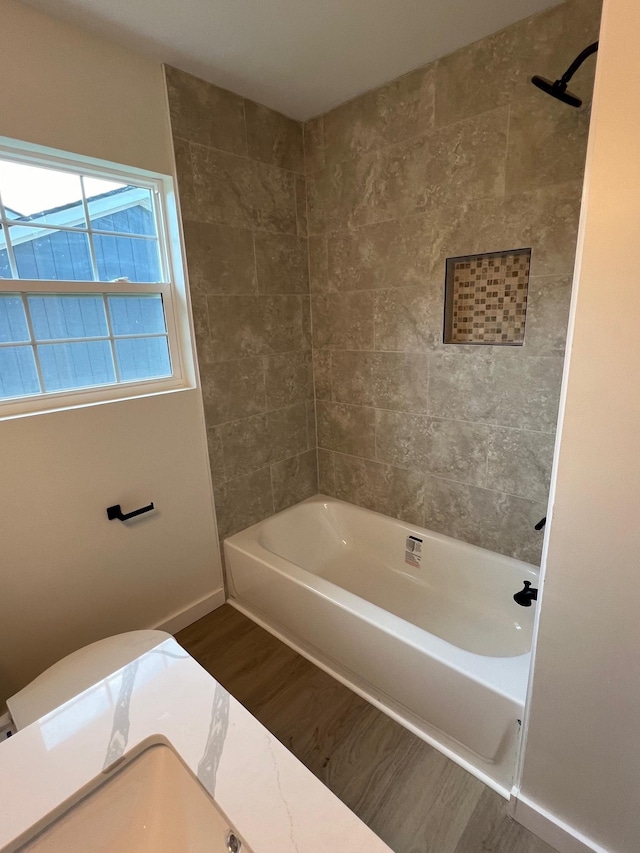 bathroom with hardwood / wood-style flooring and shower / bath combination