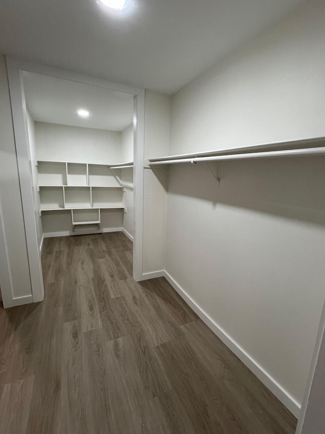 spacious closet with dark hardwood / wood-style floors