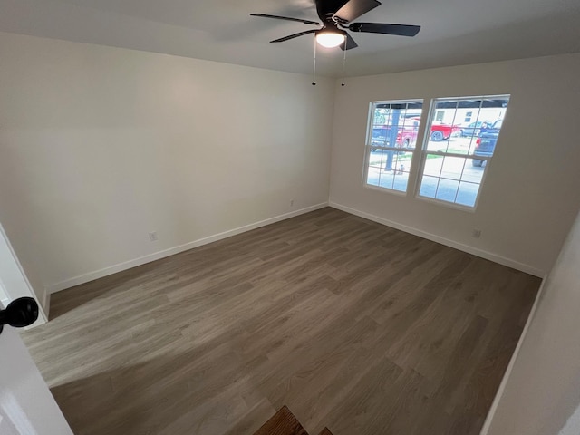 unfurnished room with dark hardwood / wood-style floors and ceiling fan