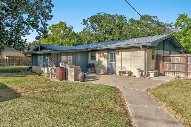 back of property featuring a yard