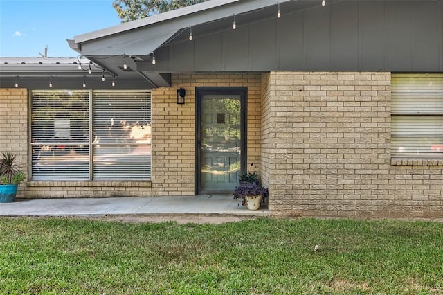 doorway to property with a yard