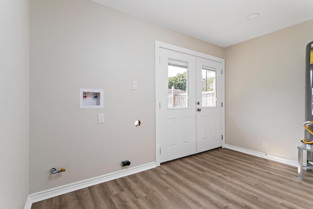 washroom featuring hookup for a washing machine, light hardwood / wood-style flooring, french doors, and gas dryer hookup