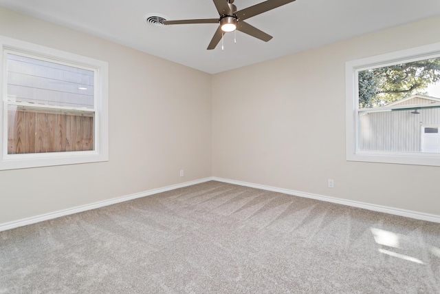 carpeted empty room featuring ceiling fan