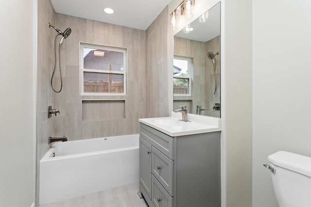 full bathroom featuring vanity, toilet, and tiled shower / bath combo