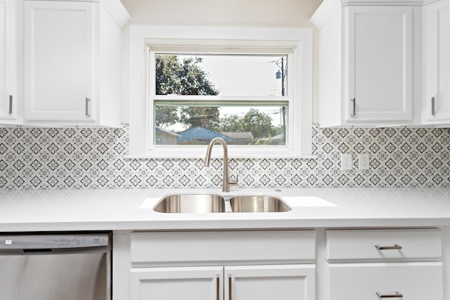 kitchen featuring stainless steel dishwasher, a healthy amount of sunlight, white cabinetry, and sink