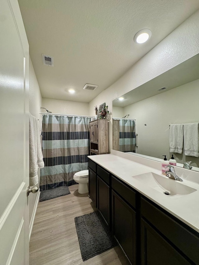 22043 Rocky Reserve Dr, Northwest Harris, TX 77447 - full bath with visible vents, toilet, vanity, and wood finished floors
