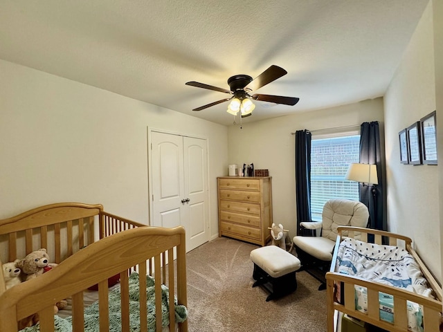 22043 Rocky Reserve Dr, Northwest Harris, TX 77447 - bedroom with carpet, a nursery area, a textured ceiling, a ceiling fan, and a closet