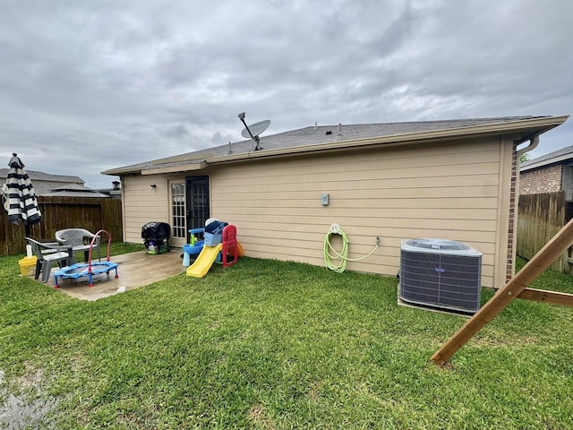 22043 Rocky Reserve Dr, Northwest Harris, TX 77447 - rear view of house featuring a yard, central AC, fence, and a patio area