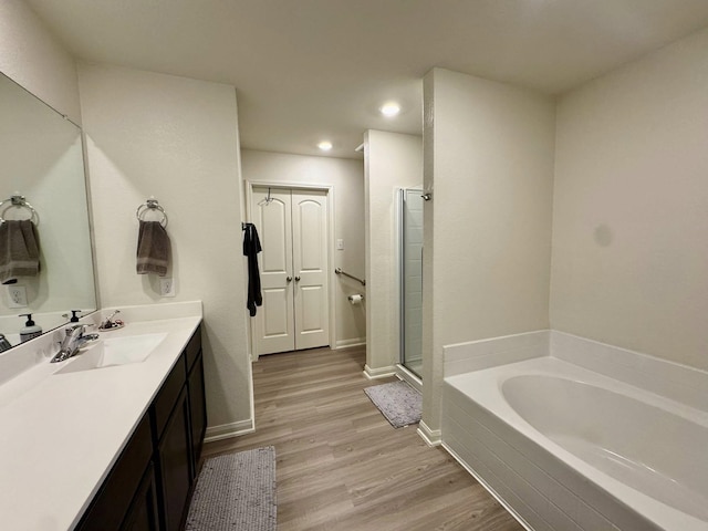 22043 Rocky Reserve Dr, Northwest Harris, TX 77447 - full bath featuring vanity, a shower stall, wood finished floors, a bath, and recessed lighting