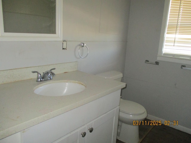 bathroom featuring toilet and vanity