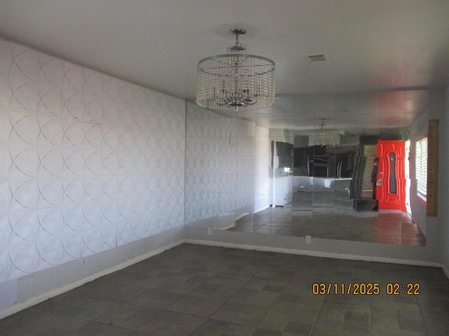 corridor featuring tile patterned floors, visible vents, baseboards, and a notable chandelier