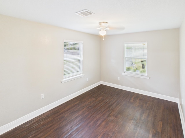 1325 S Main St, Vidor, TX 77662 - unfurnished room featuring baseboards, visible vents, dark wood-style floors, and ceiling fan